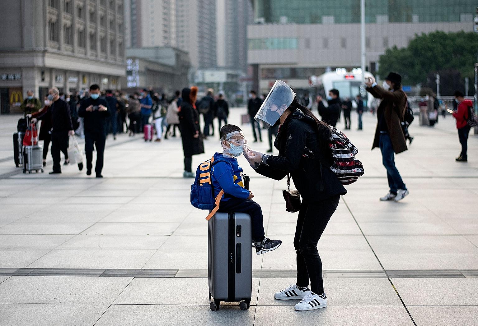 A woman and her son at Hankou railway station in Wuhan, the Chinese city where the coronavirus first emerged late last year. Infectious diseases expert Wang Linfa says the coronavirus responsible for Covid-19 is one of several viruses that likely ori