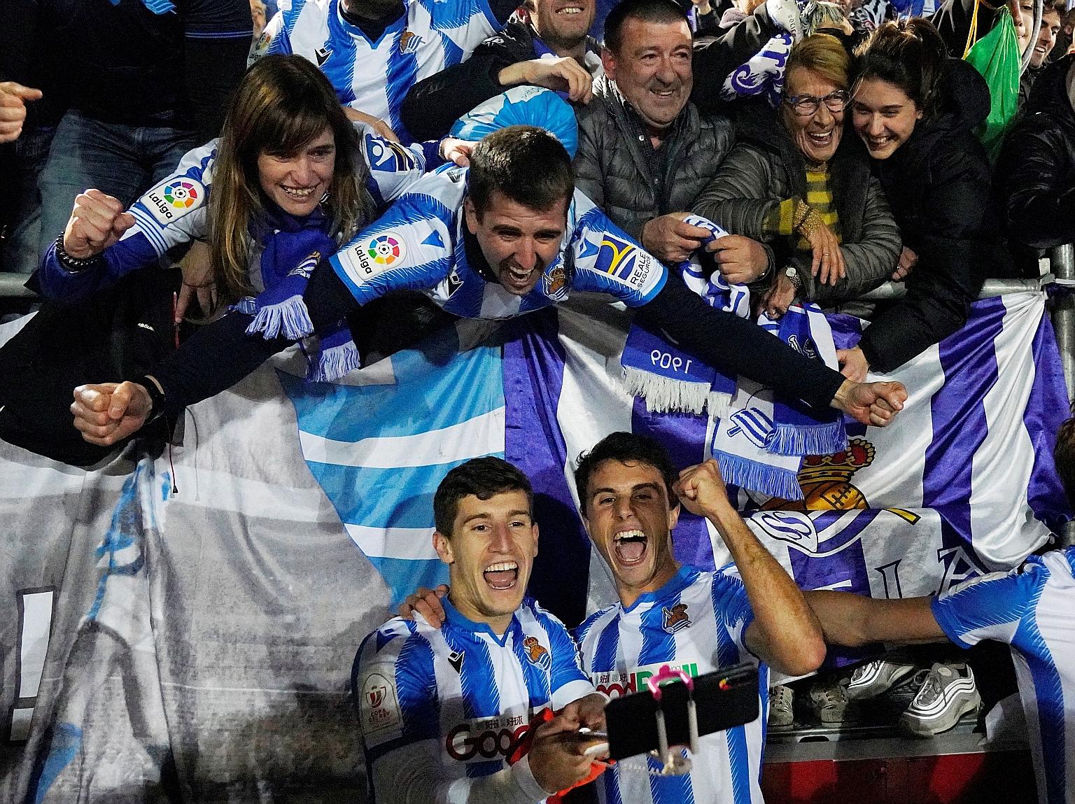 Sociedad players celebrating with fans after reaching the King's Cup final last month. Should play not resume, their opponents, Basque rivals Bilbao, are likely to get into the Europa League as fourth-placed Sociedad will play in the Champions League.
