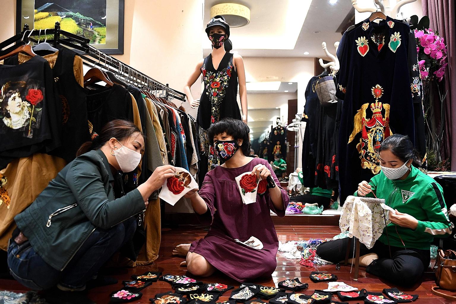 Vietnamese sewing face masks. Millions of jobs are at stake in Vietnam, one of the world's largest garment exporters, as companies in Western markets cancel orders or hold up shipments of completed goods. PHOTO: AGENCE FRANCE-PRESSE