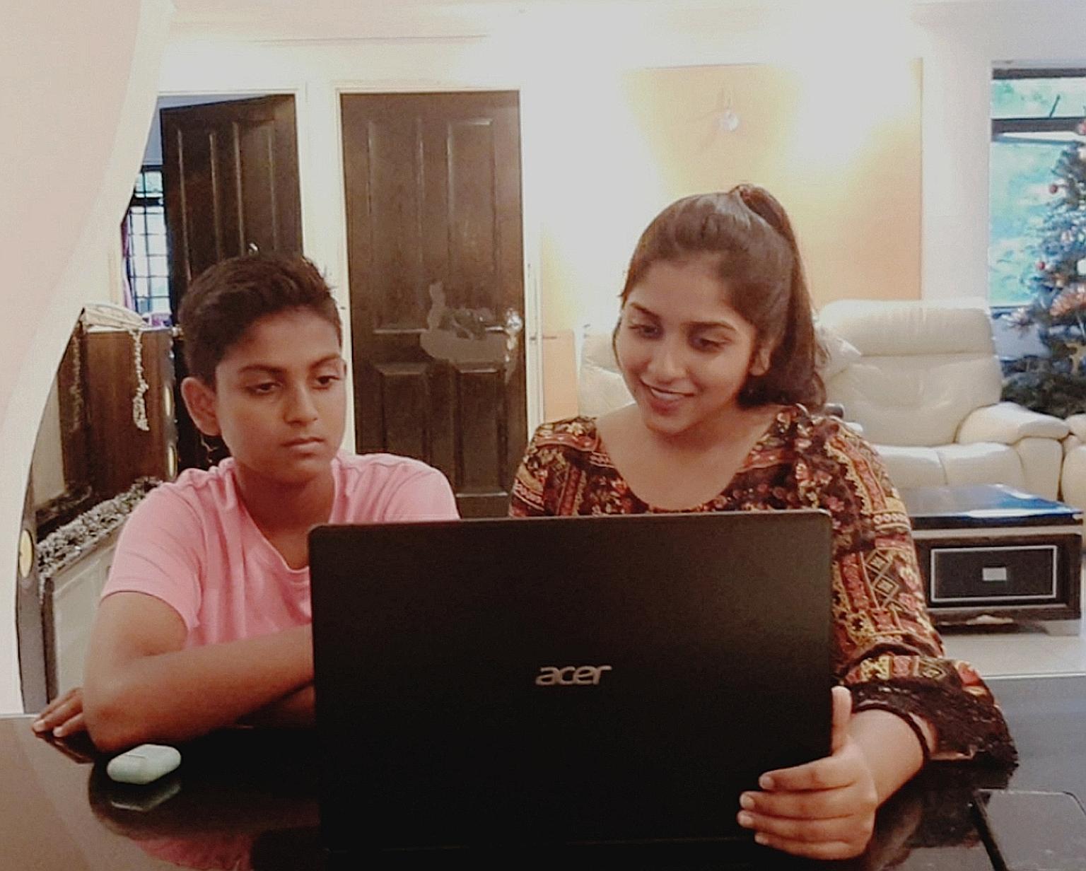 Sheryl Shivani, with her brother Gerald Giresh Raj, says she can complete her online assignments faster now that she has a laptop. In the past, she relied on her mobile phone, which could not support all the features she needed for e-learning.