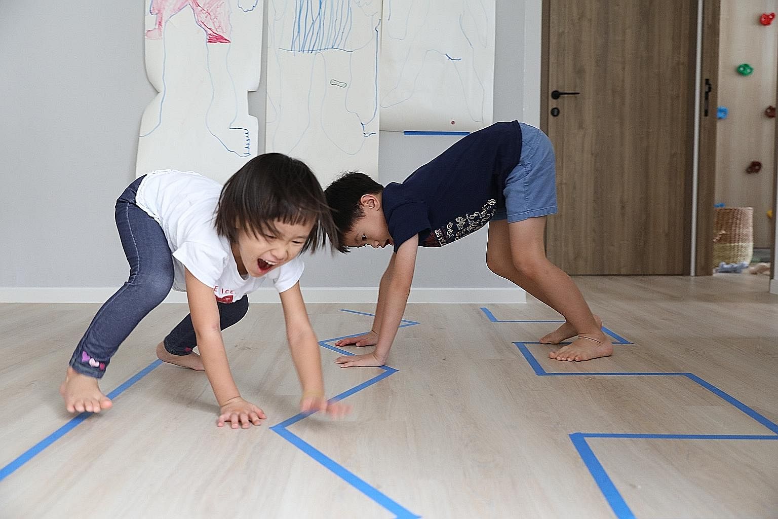 Parents can use items in the house to create activities for children, says Ms Fynn Sor, who runs an activity resource website called Happy Tot Shelf. Here, her children, Riley, four, and Zachary, seven, go through a line obstacle course where they tr