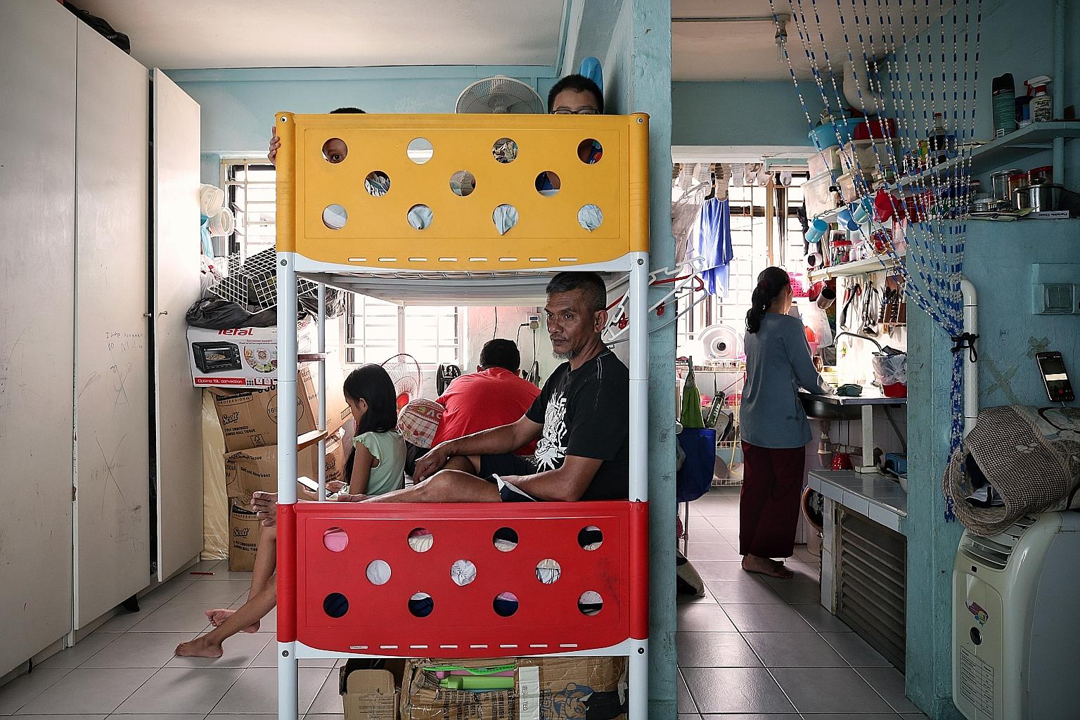 Adam (not his real name), 54, who was working as a cleaner, with his wife and children in their one-room rental flat. ST PHOTO: KEVIN LIM