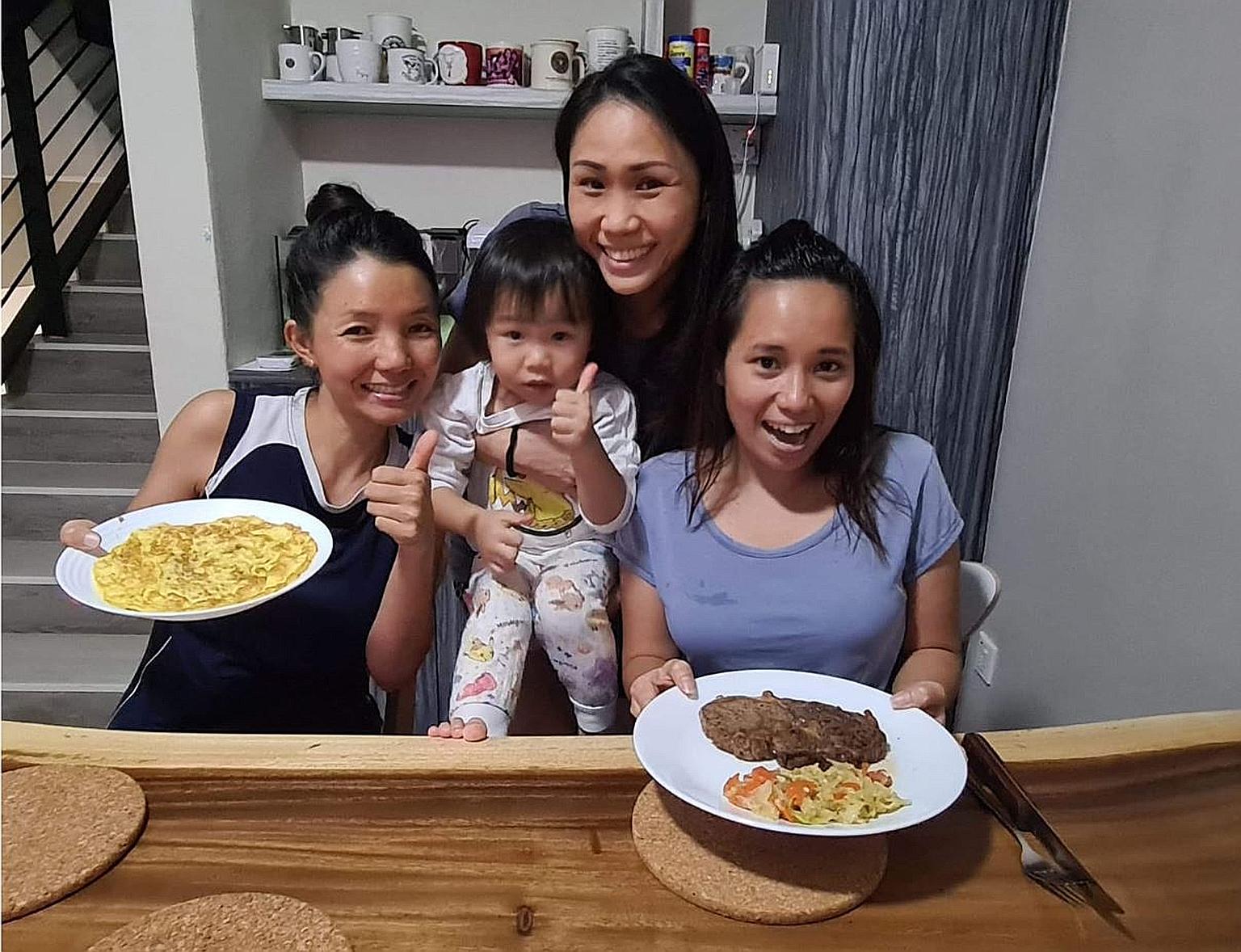 Fund manager Henrietta Yap, holding her daughter Beth, with her domestic helpers Kay Thi Khaing (left) and Alena Pacardo Palencia (right). With the circuit breaker in place, Ms Yap makes an effort to pitch in more at home. On Friday, she let her help