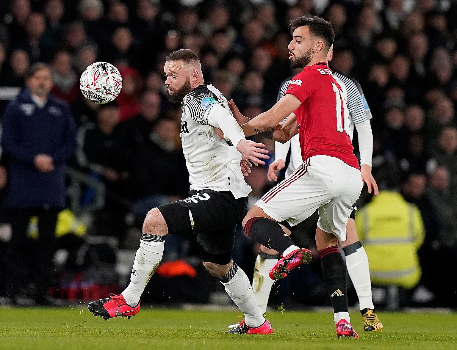 Derby's Wayne Rooney in action against his old club Manchester United and midfielder Bruno Fernandes in their FA Cup fifth-round tie at Pride Park on March 5. The visitors won 3-0 before the season was suspended a week later. Rooney managed 253 and 5