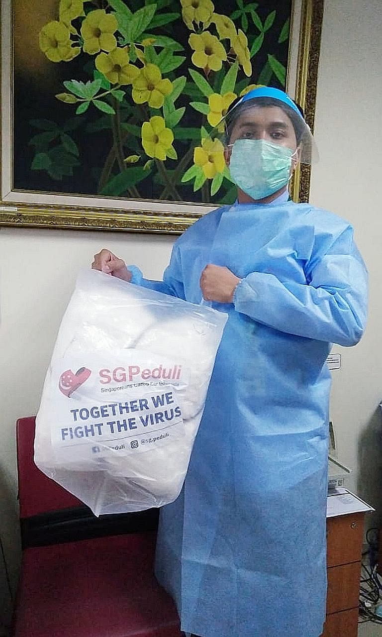 Harapan Kita National Heart Centre's medical record officer Agung Sutrisno, 24, with the donations from SGPeduli. PHOTO: HARAPAN KITA NATIONAL HEART CENTRE