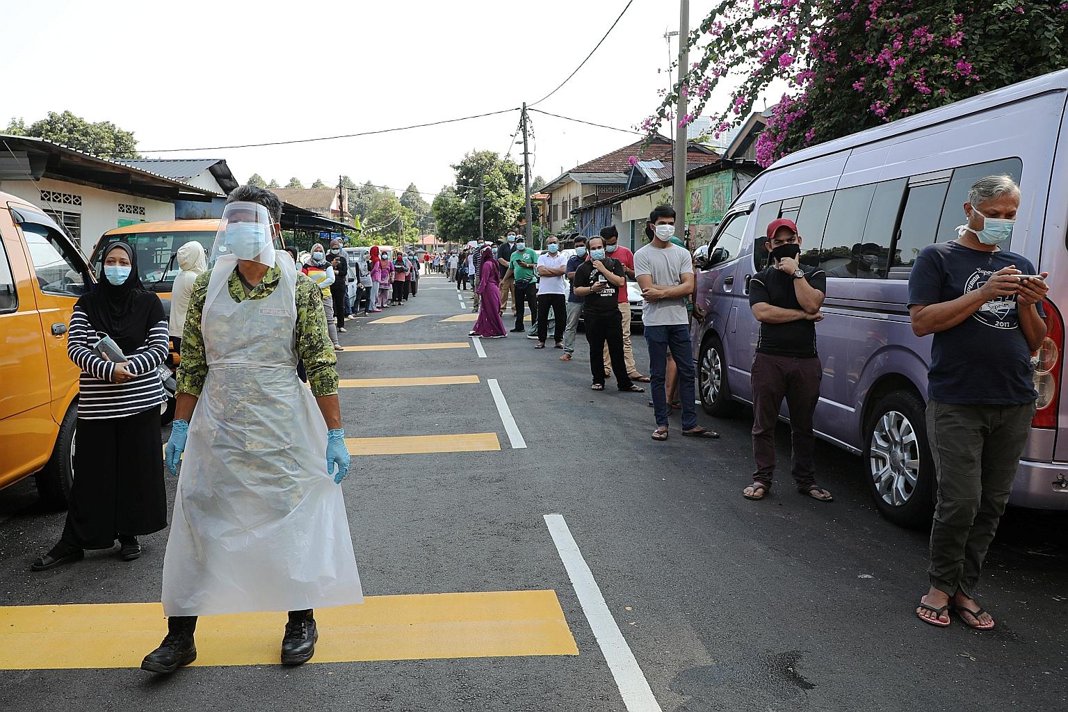 People waiting to be tested for the coronavirus at a makeshift centre in Kampung Baru, Kuala Lumpur, last weekend. Malaysia reported 36 new infections yesterday, the lowest since it imposed movement curbs on March 18. But there are concerns over the 