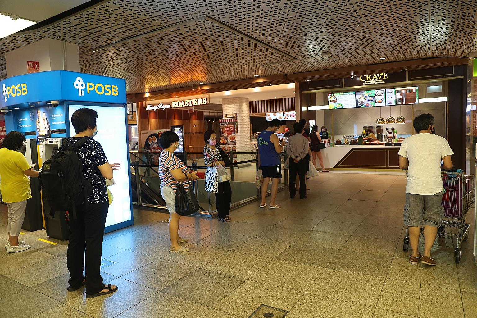 Shoppers keeping a safe distance from one another at Jem mall yesterday. More than 80 per cent of respondents in the Reach survey said they consciously kept a safe distance from others when they were out of the house. ST PHOTO: TIMOTHY DAVID
