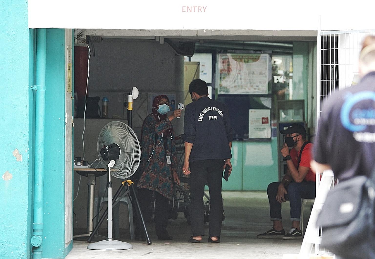 Temperature screening last Friday at one of the vacant Housing Board blocks in Taman Jurong that are being refurbished to house workers in essential services. Such workers who have moved out of dormitories are staying in alternative abodes such as fl