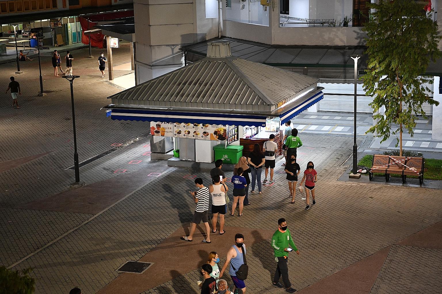 A queue forming at a bubble tea and dessert shop in Tampines Street 81 at about 9.30pm yesterday as more businesses were told to close by midnight. ST PHOTO: ARIFFIN JAMAR