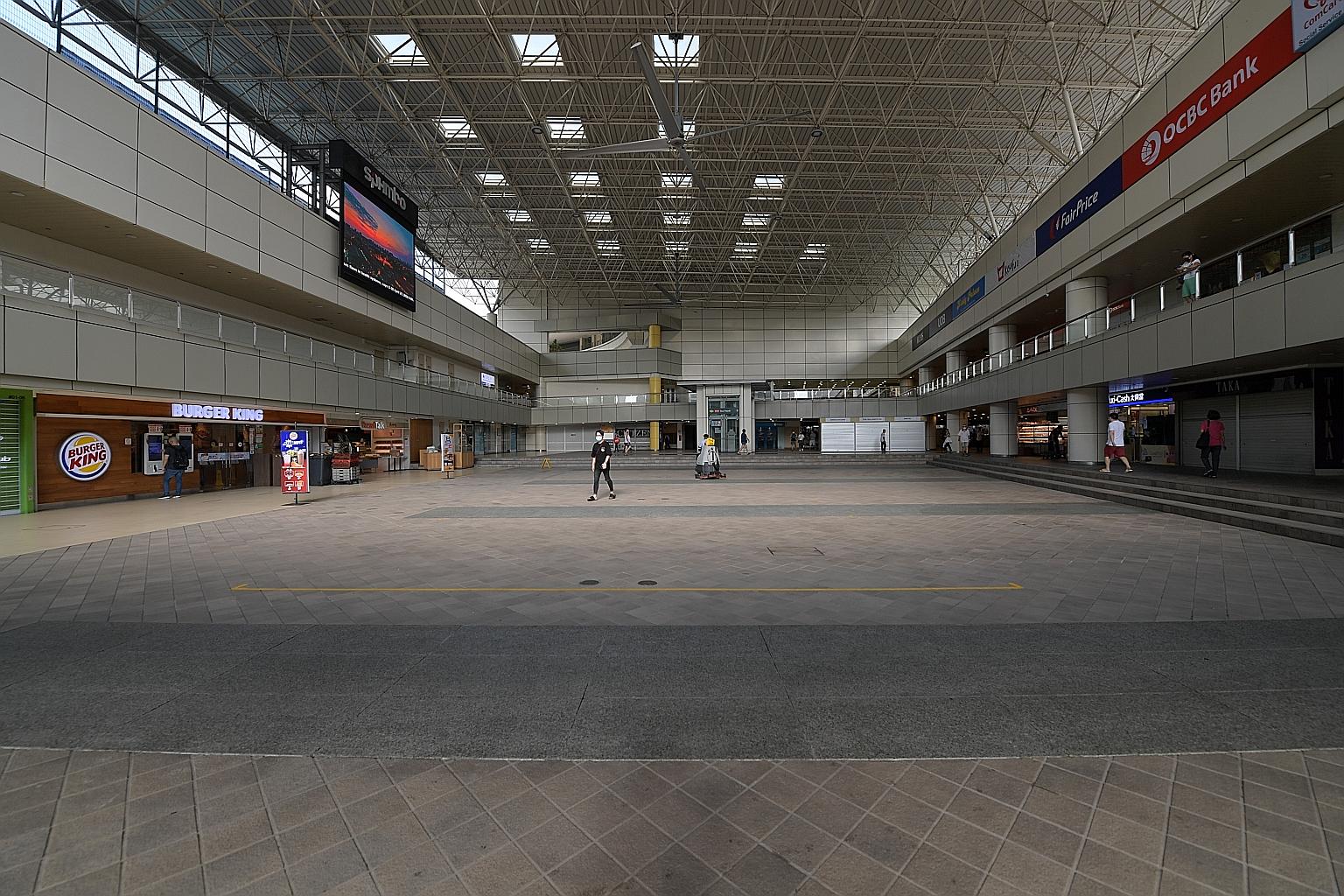 Left: Benches in Tampines taped off to prevent people from sitting on them. PM Lee urged people to install and use apps such as TraceTogether, saying they will work only if everyone cooperates. ST PHOTO: LIM YAOHUI Left: Few people were seen out and 