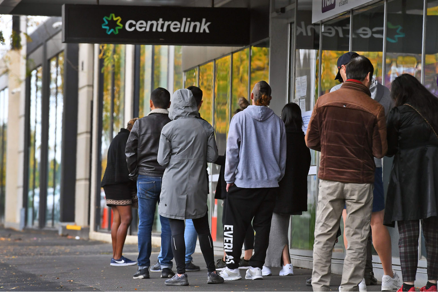 People queueing outside a Centrelink office in Melbourne on Monday. Most of the services provided by government agency Centrelink involve the disbursement of social security payments.
