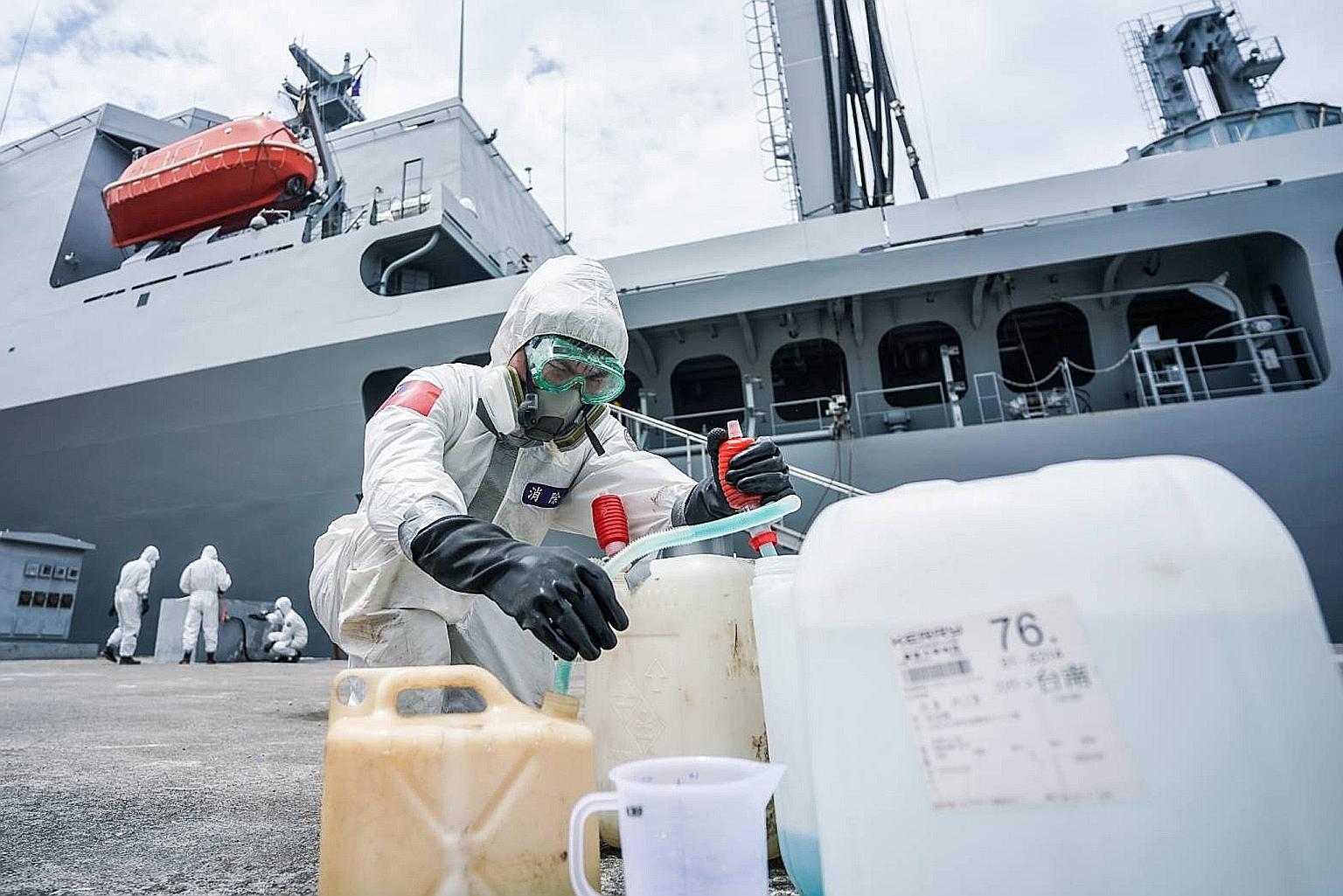 Military chemical unit soldiers disinfecting a navy supply ship which returned to Taiwan on April 9 after visiting Palau. Twenty-eight people who had been on the ship were later found to be infected with the coronavirus.