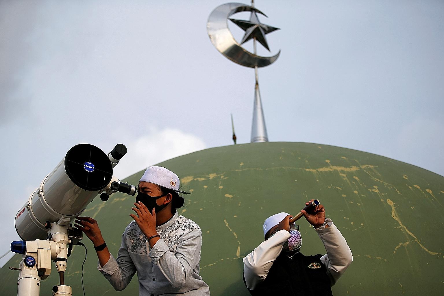 Students using equipment to view the moon on the roof of Al Musariin mosque to mark the first day of Ramadan yesterday.