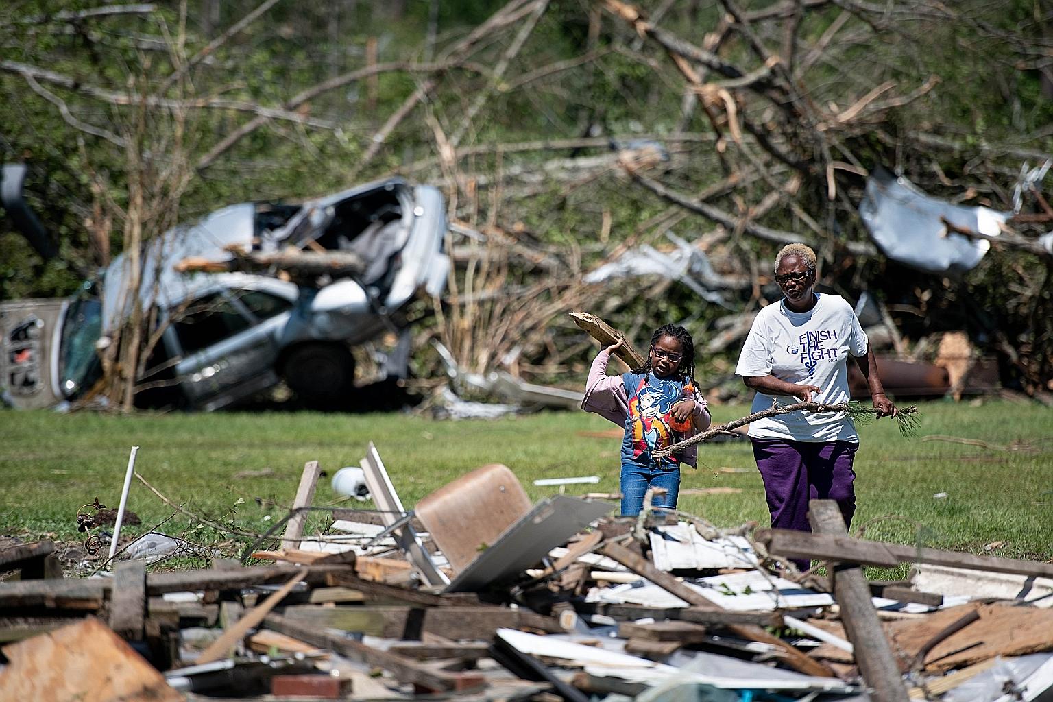 People clearing up debris in South Carolina last week, after a string of storms across the southern US that began on Easter Sunday. This Wednesday, storms and a tornado swept through Texas and Oklahoma, killing at least six people and injuring dozens