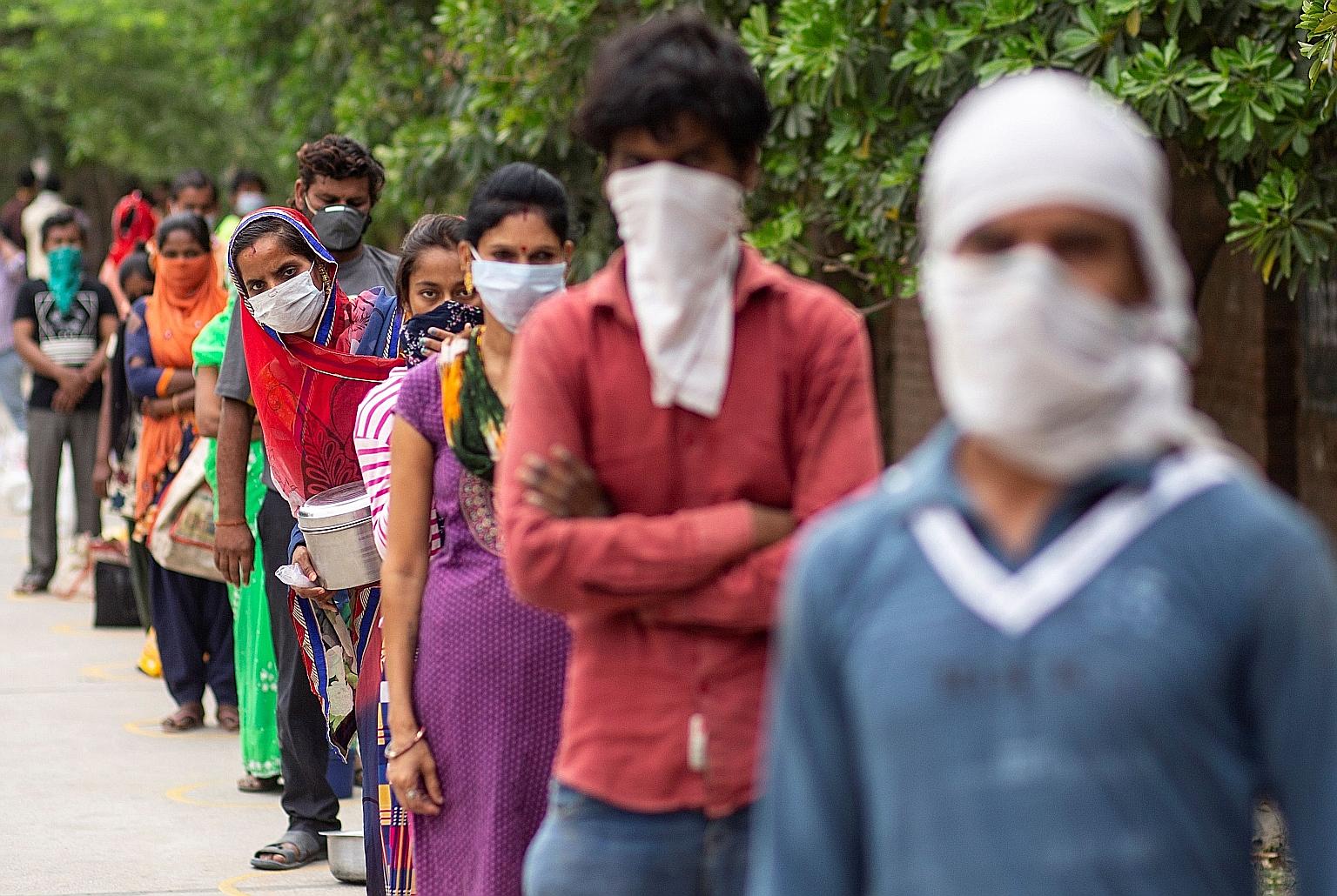 People in a New Delhi industrial area waiting to receive food during the Covid-19 lockdown. Eighteen of 30 Indian tech start-ups, the main beneficiaries of Chinese investors last year, already have Chinese capital.
