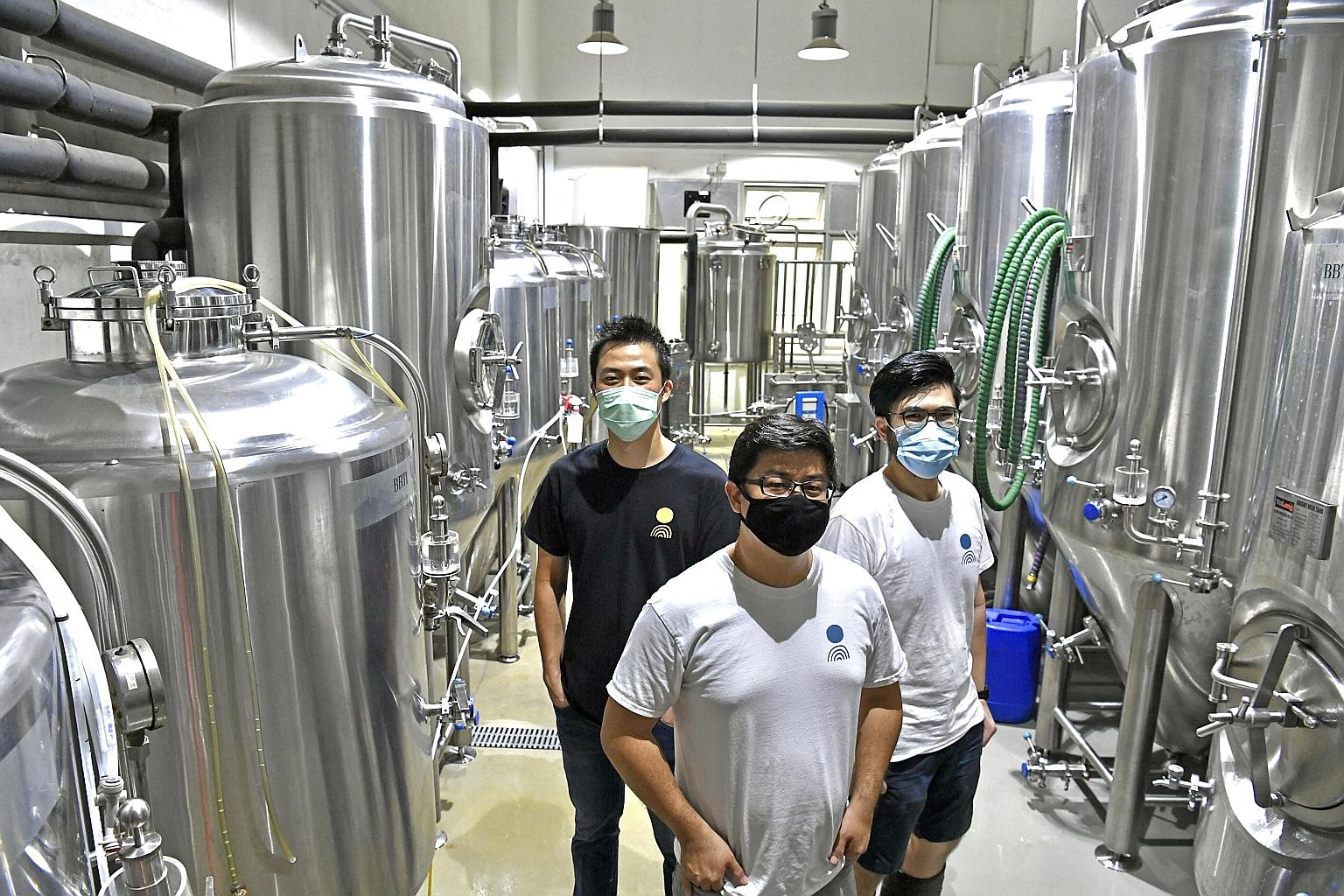 (From left) Off Day Beer Company co-founders Kasster Soh, 33, Kevin Ngan, 39, and Daryl Yeap, 29, at their brewery in Jurong Food Hub. Mr Ngan said that the fund transfer service, which he applied for through OCBC Bank, was particularly useful during