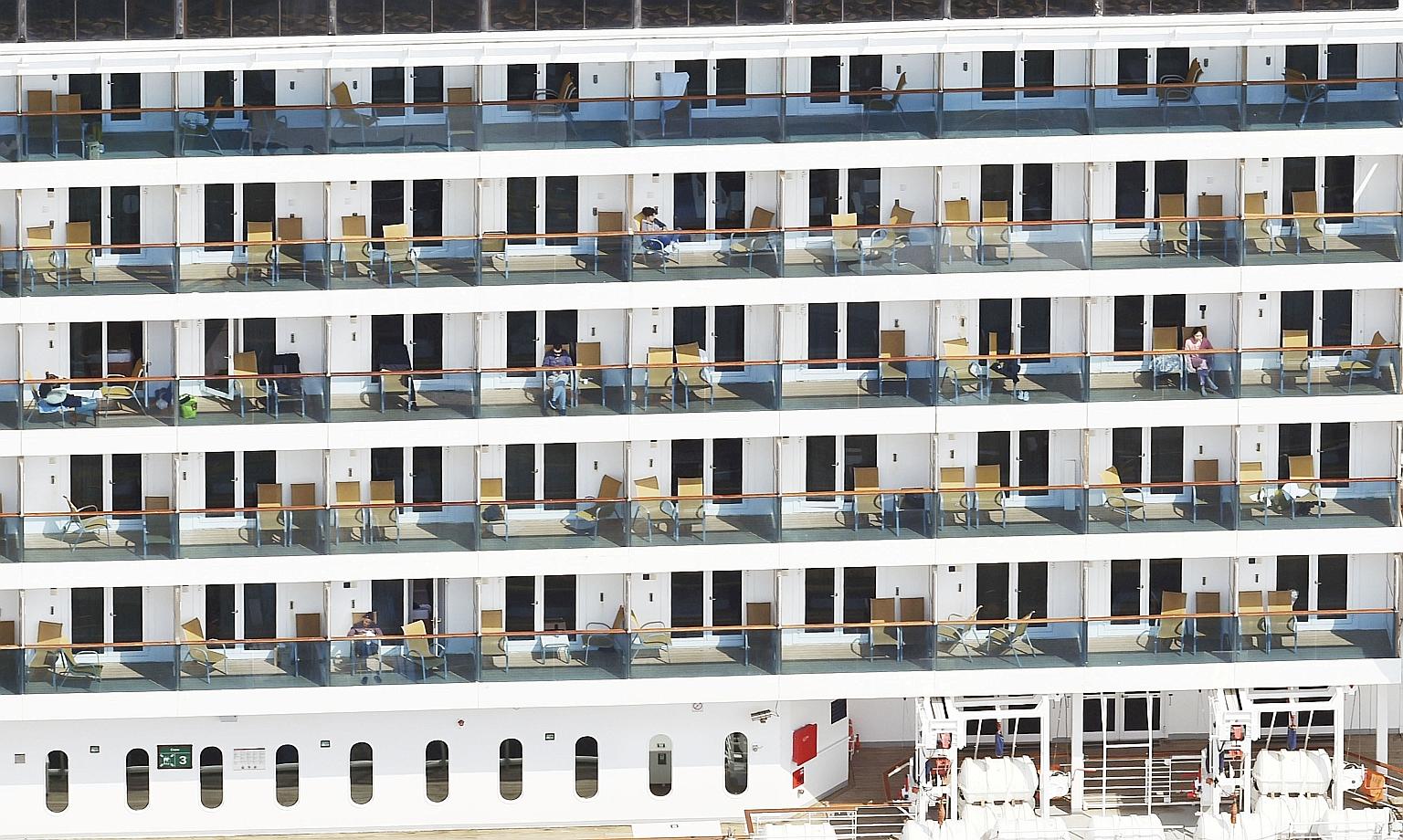 Crew members on Italian cruise ship Costa Atlantica docked off Nagasaki for repairs, in this photo taken by Kyodo yesterday. The ship has 148 coronavirus cases so far among the 623 people on board.