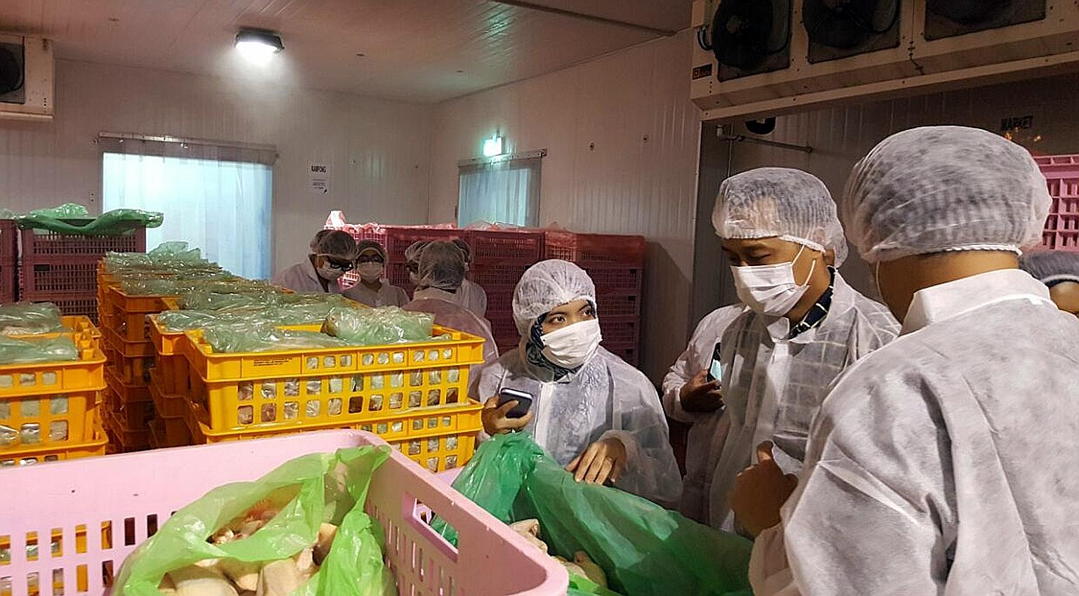 Muis' Halal Certification Strategic Unit officers looking at the processes of a halal chicken slaughtering centre. Muis said key decisions on halal certification are not made by one person, but by an independent panel. PHOTO: MUIS