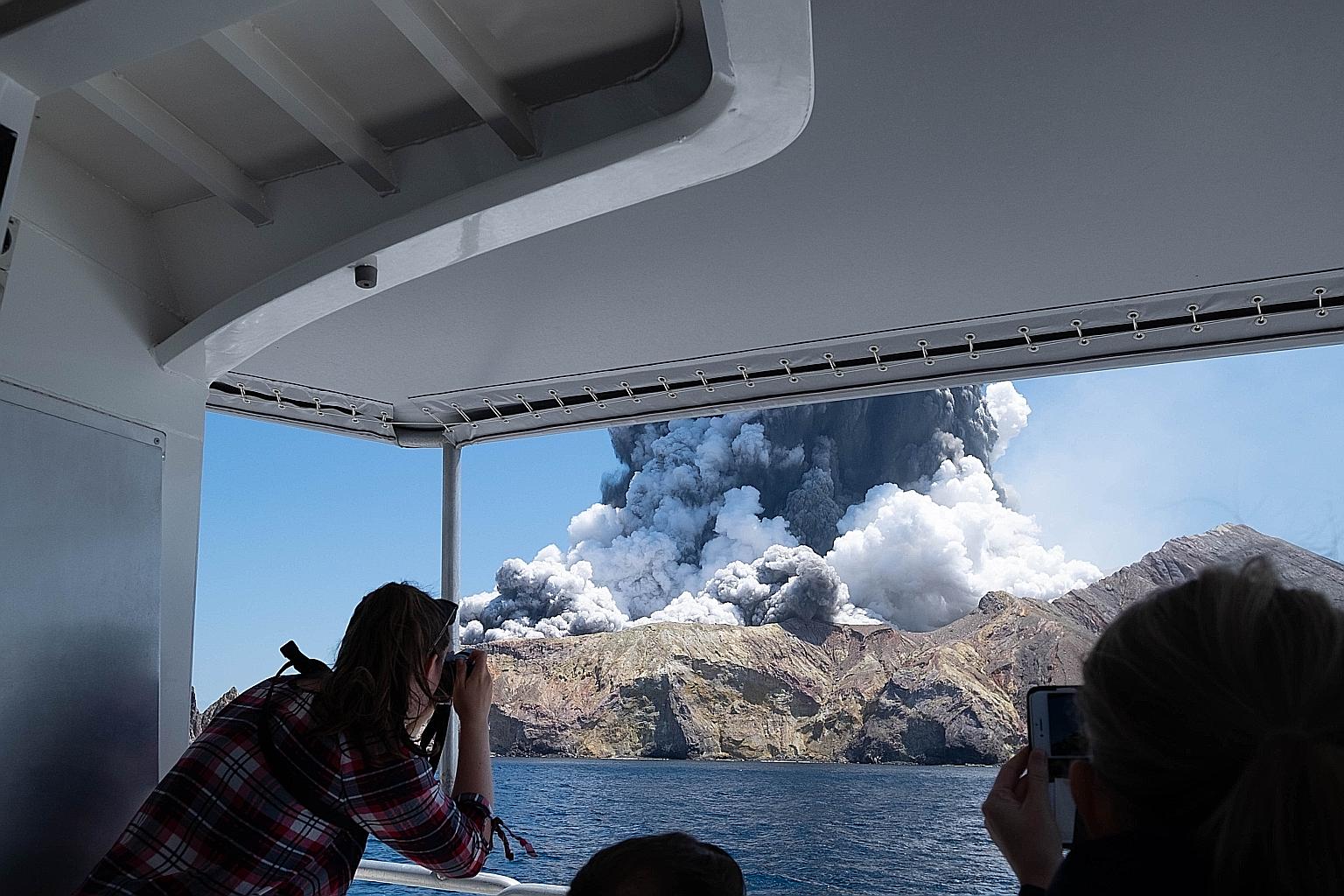Tourists on a boat looking at the eruption of the volcano on White Island, New Zealand, last Dec 9. There were 47 people on the island when the volcano erupted.