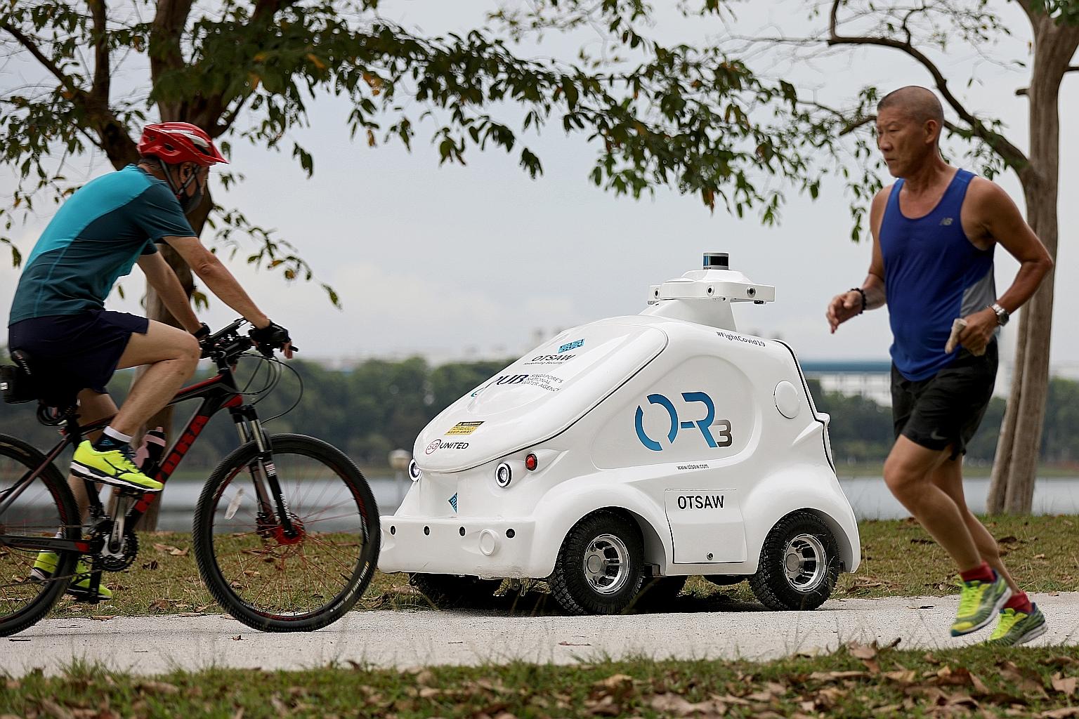 The O-R3, seen here on Monday, is a robot used by water agency PUB to broadcast safe distancing messages at Bedok Reservoir.