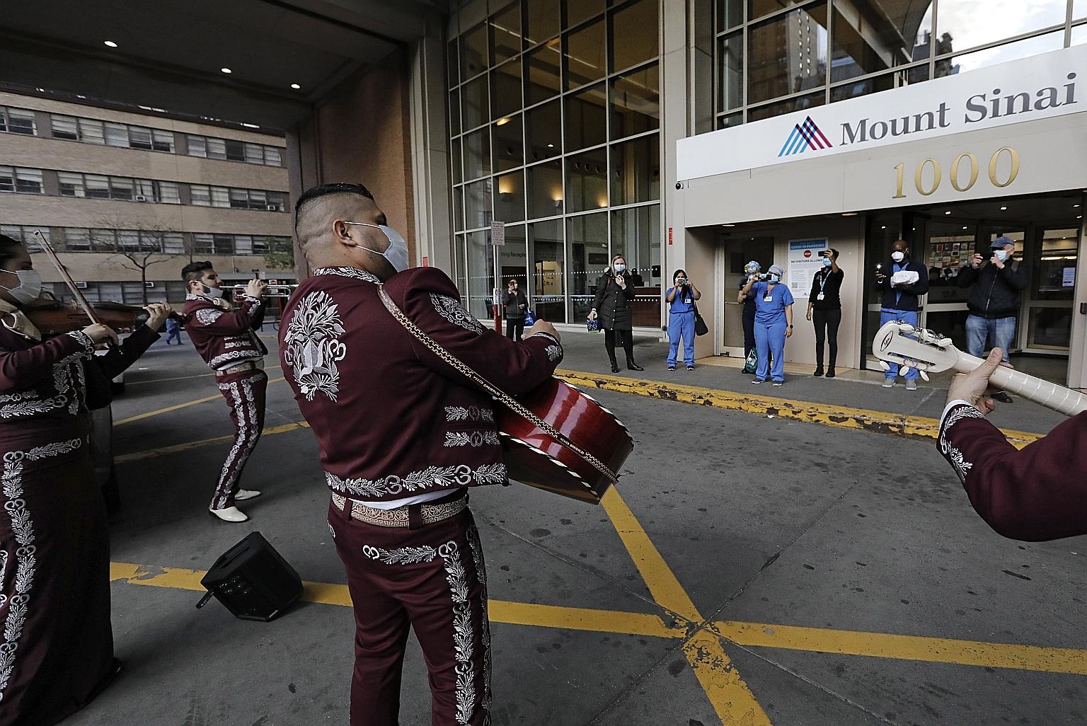 A mariachi band performing during a tribute to healthcare workers at Mount Sinai West Hospital in New York on Tuesday. New York state is still the epicentre of the coronavirus outbreak in the United States, but according to a University of Washington
