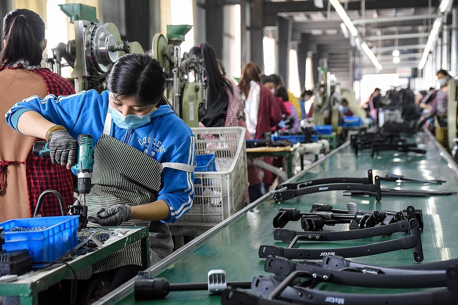 Workers at a baby carriage factory in Handan, China's Hebei province, this week. The Chinese economy took a heavy blow in the first quarter, shrinking an annual 6.8 per cent, the first contraction since current quarterly records began almost 30 years
