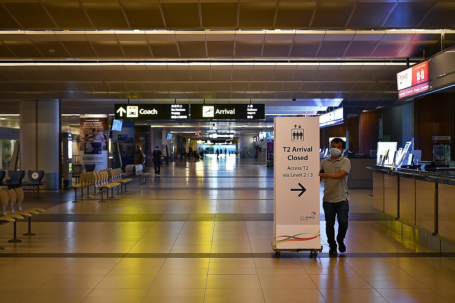A view yesterday afternoon of Changi Airport's Terminal 2 arrivals hall, where some lights were switched off and very few people were around. T2's closure, for 18 months from today, allows the airport to cut costs as well as speed up its expansion wo