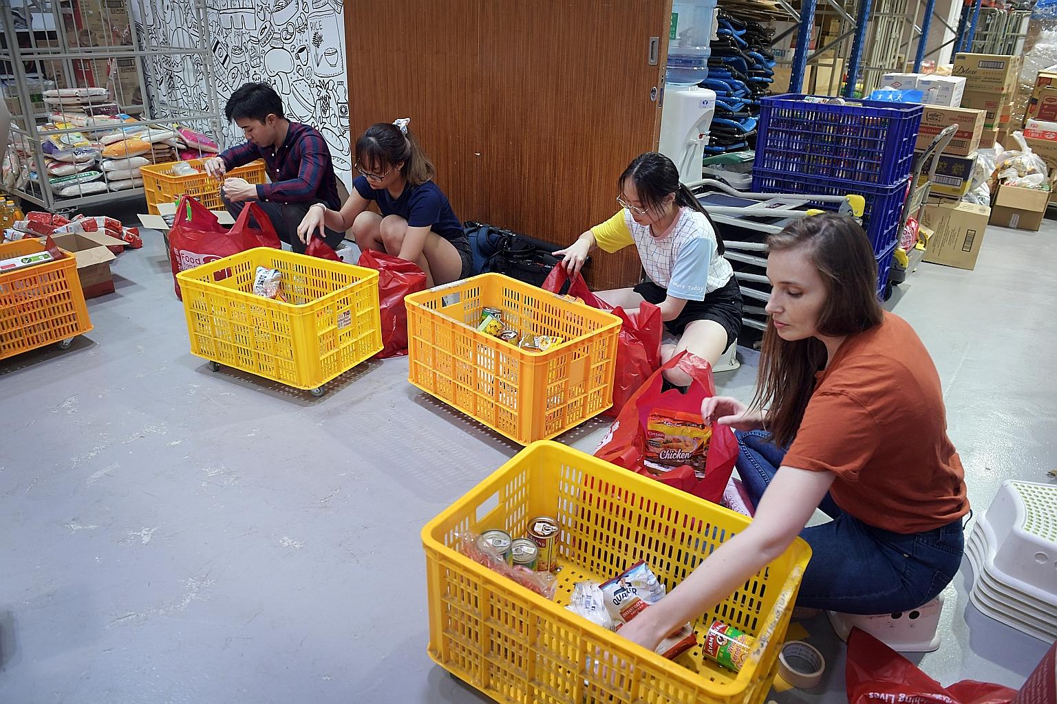 Volunteers and staff of Food from the Heart packing food at their warehouse earlier last month for distribution to beneficiaries.