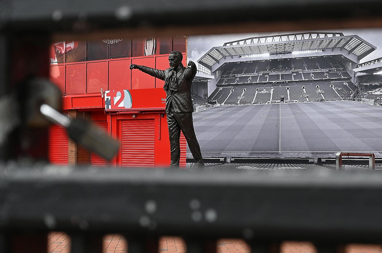 The statue of Liverpool legend Bill Shankly as seen through a locked gate at Anfield. Liverpool are the runaway leaders of the EPL, which hopes to resume next month.