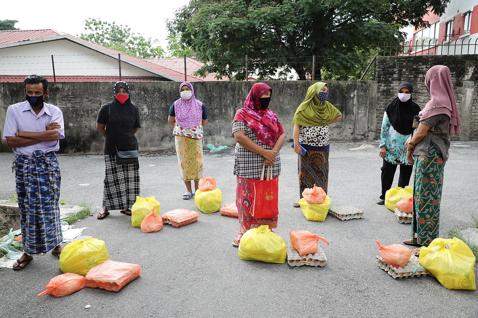 Rohingya refugees in protective masks keeping a safe distance while waiting to receive goods from volunteers, during the ongoing movement control order, in Kuala Lumpur early last month. Malaysia had opened up its borders in 2017 to provide temporary