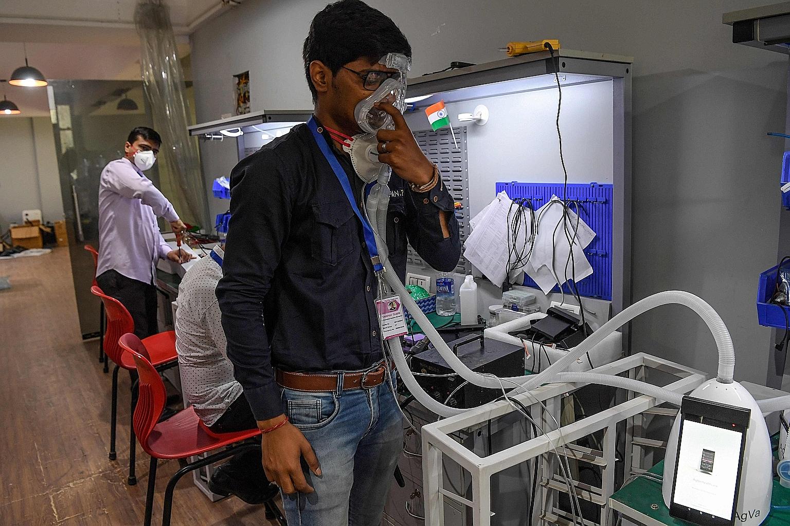 An AgVa Healthcare employee showing how the company's ventilator works, at the research centre in Uttar Pradesh state, in March. The company came up with the toaster-sized ventilator that is priced at less than a fourth of conventional ventilators, a
