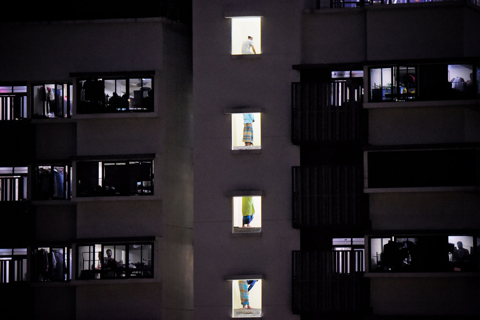 Muslim migrant workers performing Maghrib prayers at the Westlite Toh Guan Dormitory, after breaking fast yesterday. Workers at all the dorms have not been allowed to leave their premises since last Tuesday as part of tighter circuit breaker measures