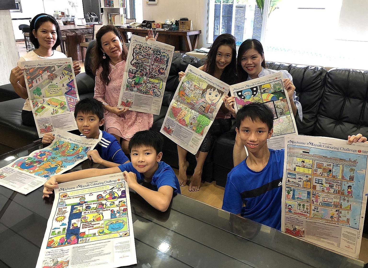 The Goh family and their helper Karen Sanfuego (left), 29, each took charge of one visual. Ms Chrisashley Tok (right), 38, with the four children (front row, from left) Lennon, 11, Modric, nine, Keane, 13, and Tracy (back row, second from right), 29, and 
