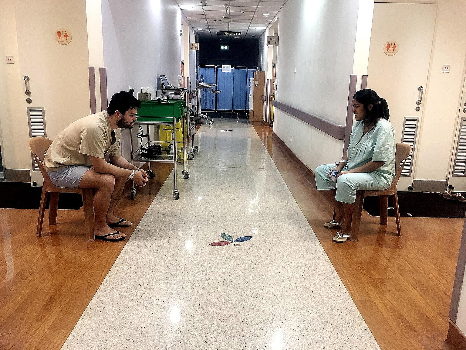Left: Mrs Natasha Ling and her husband Pele with baby Boaz, who was born on April 26. Below: At the National University Hospital, the couple were in opposite wards separated by a 2m-wide corridor. PHOTOS: MATHEW PEREIRA, PELE LING