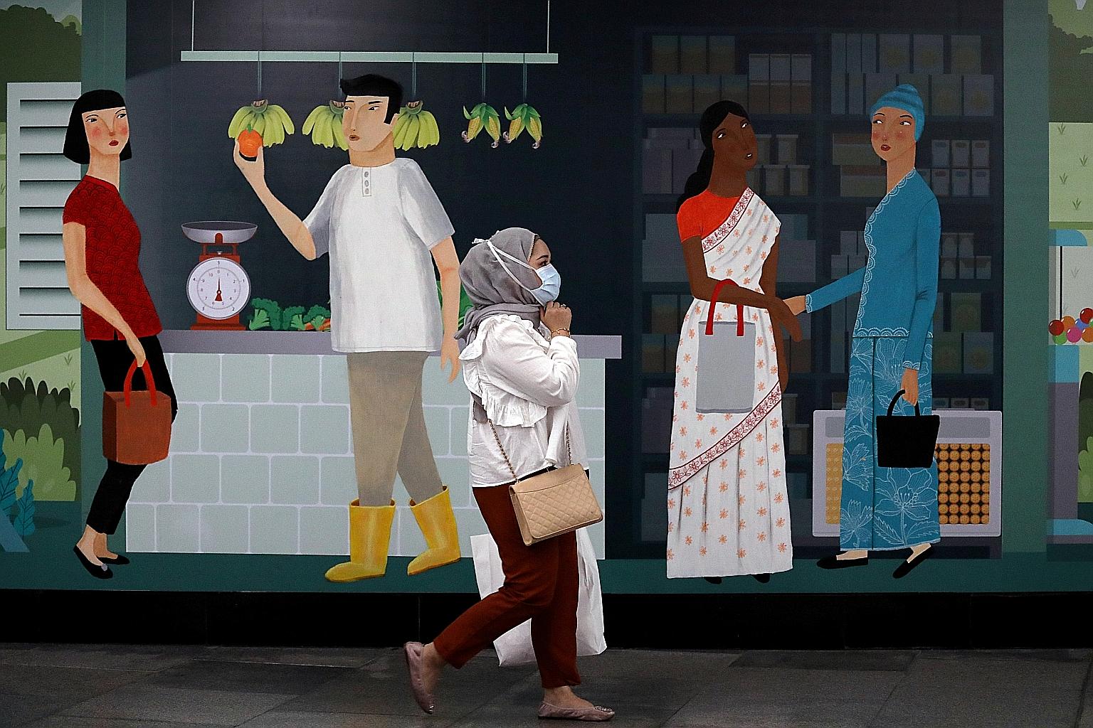 A woman wearing a mask outside a train station in Kuala Lumpur. Malaysia's move to relax the movement control order tomorrow ahead of its May 12 expiry has sparked criticism over the hasty reopening, while new infections rose back to triple digits ye