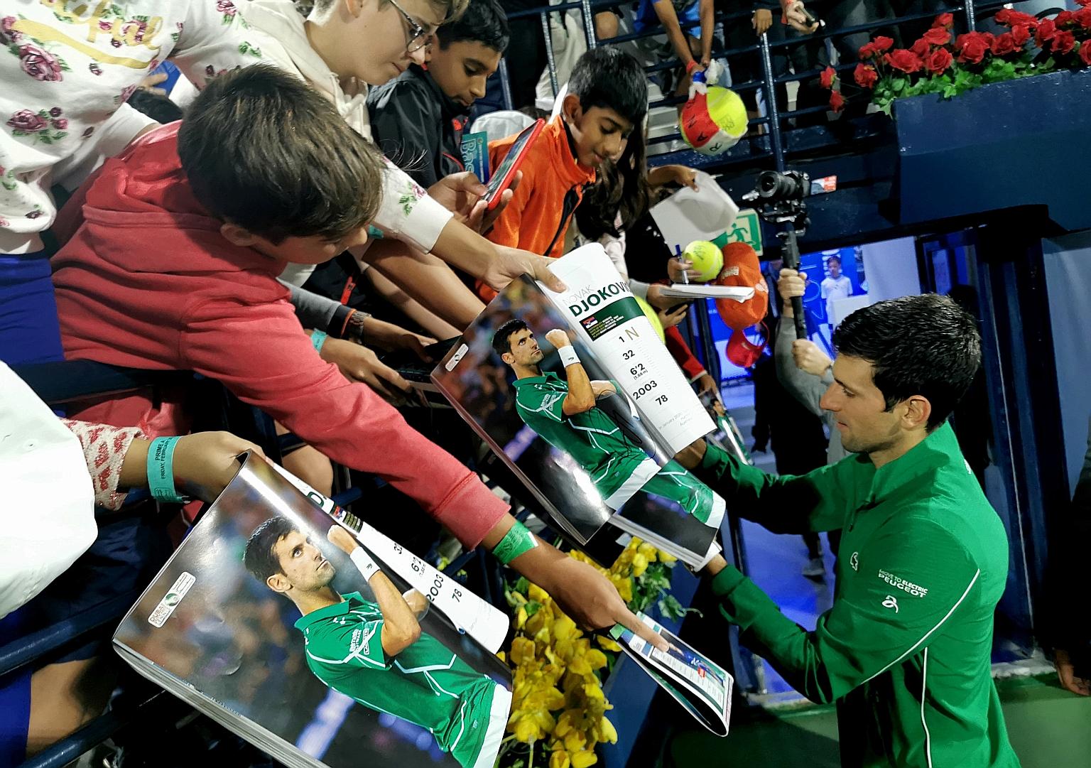 World No. 1 Novak Djokovic signing autographs for fans in Dubai in February. This is being discouraged under the new ITF guidelines, while players cannot even shake hands or shower after their matches.