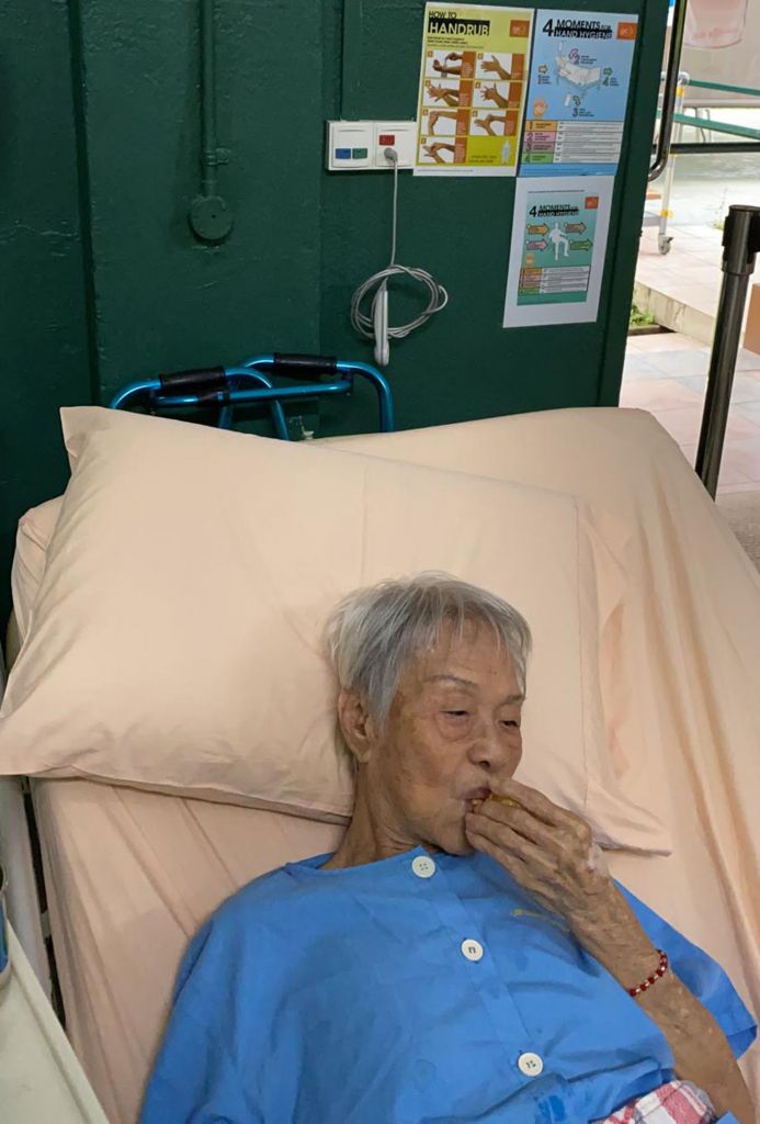 Madam Yap Lay Hong enjoying durian puffs yesterday, a day after her discharge from hospital. 818 Durians owner Goh Meng Chiang had provided durian puffs and cakes for the Lee Ah Mooi residents and staff.