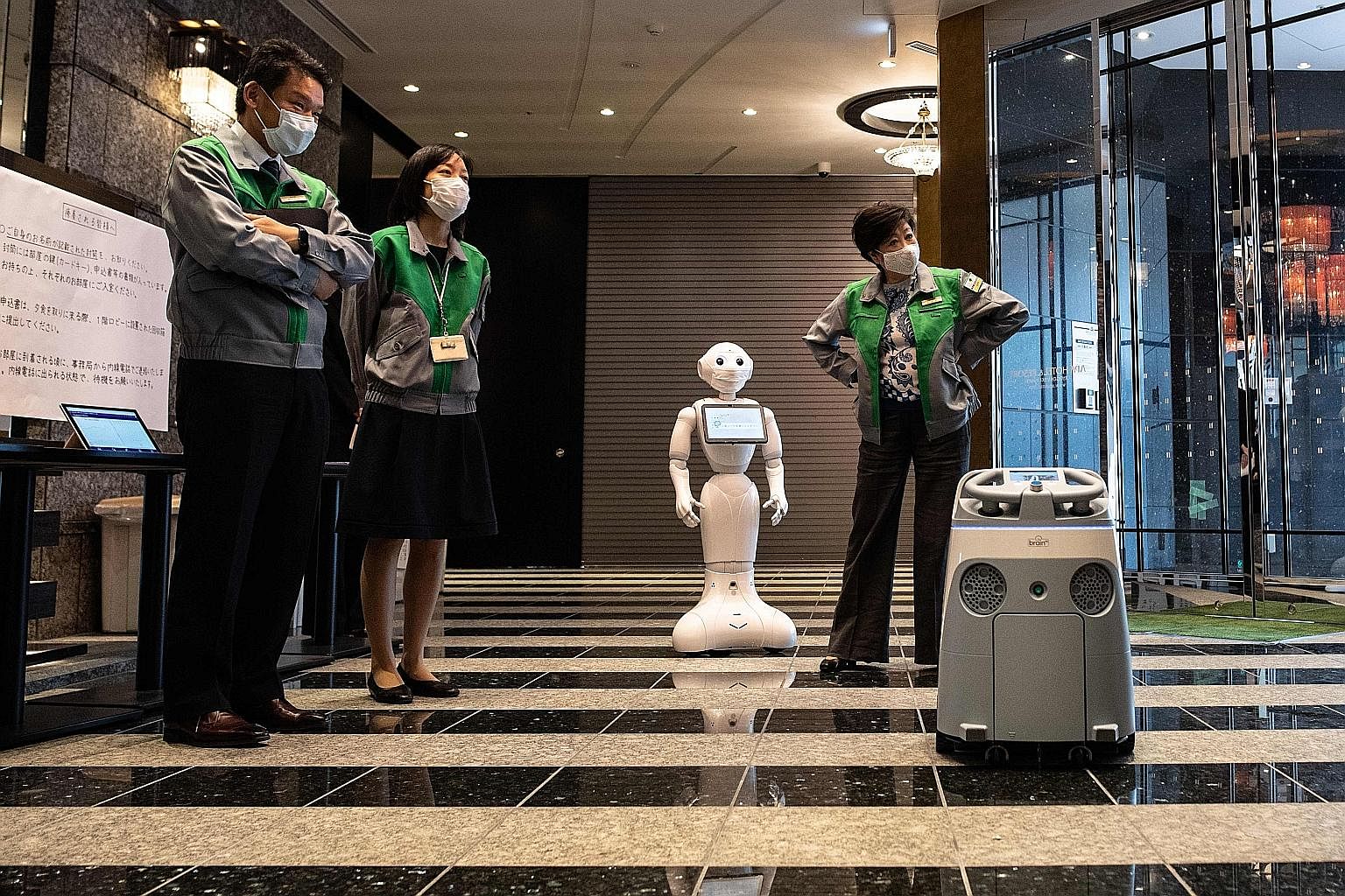 A greeting robot called Pepper welcoming Tokyo Governor Yuriko Koike (right) to a hotel in the Japanese capital on Friday while a cleaning robot called Whiz showed off its moves. Shifts in supply chains post-Covid-19 should lead to more investments i
