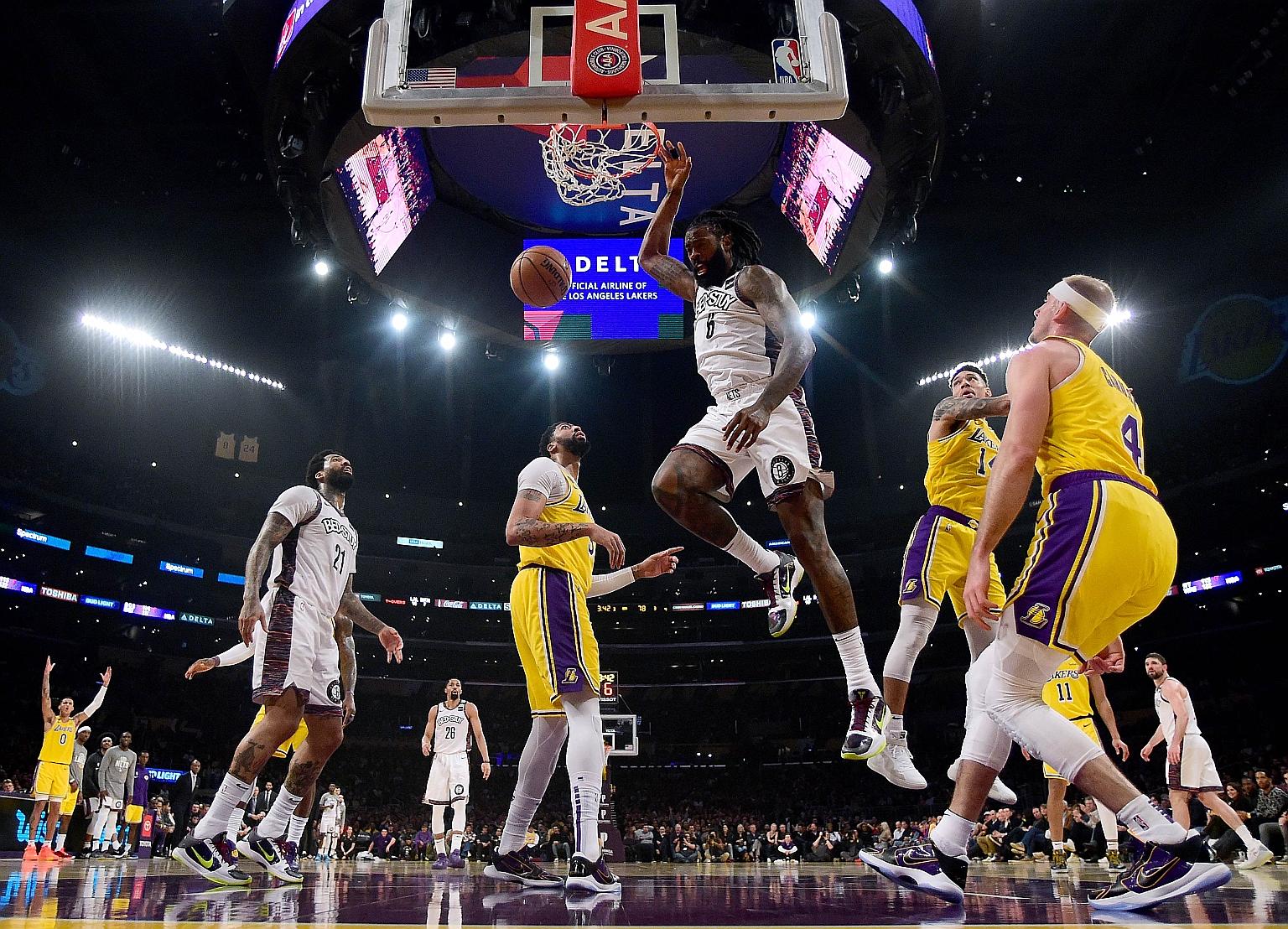DeAndre Jordan of the Brooklyn Nets dunking during his team's 104-102 win over the Los Angeles Lakers at Staples Centre on March 10, the day before the NBA season was suspended because of the coronavirus crisis. 