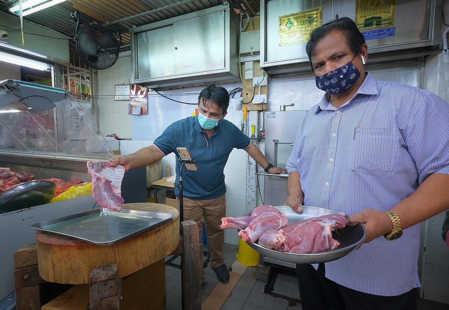 People at Tekka Market yesterday afternoon. Some stalls have reported sales plummeting by up to 80 per cent amid the pandemic. ST PHOTO: GAVIN FOO Mr Mohamed Mustafa Shahul Hamid (at right), who runs a mutton stall at Tekka Market, and his son Nizamd