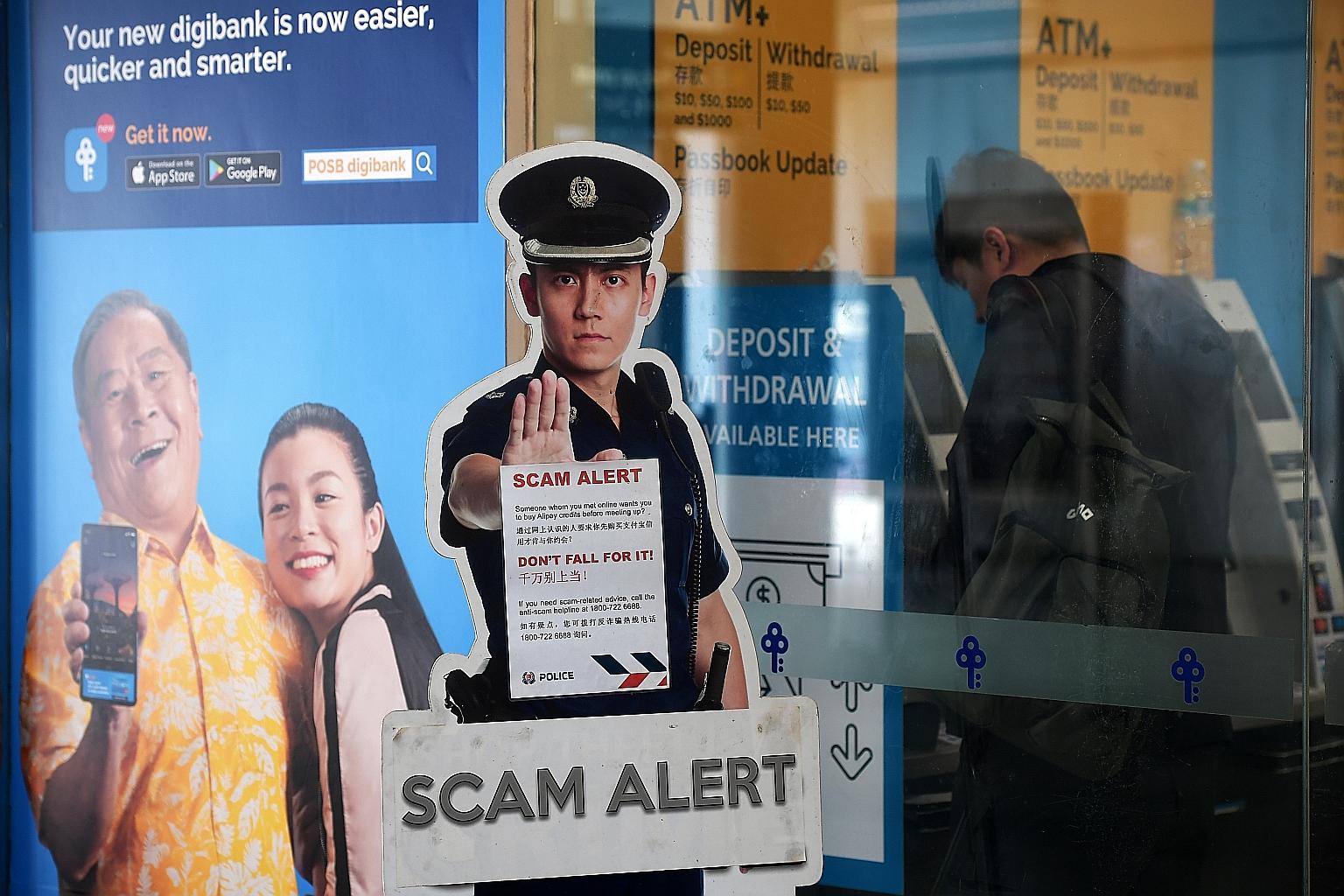 A scam alert notice put up near ATMs at Woodlands MRT station. The police also warned of a rise in bank phishing scams and Internet love scams.