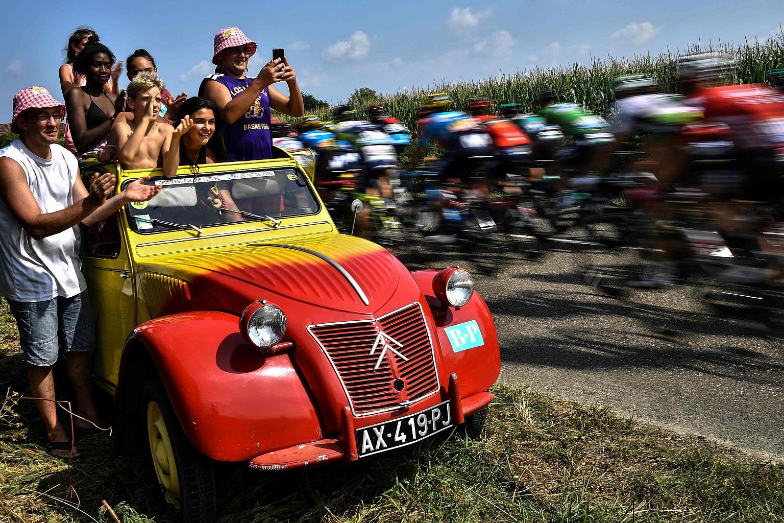 Fans lining the Tour de France route to cheer the peloton on, such as in this 2018 photo, is an enduring image of the event. PHOTO: AGENCE FRANCE-PRESSE