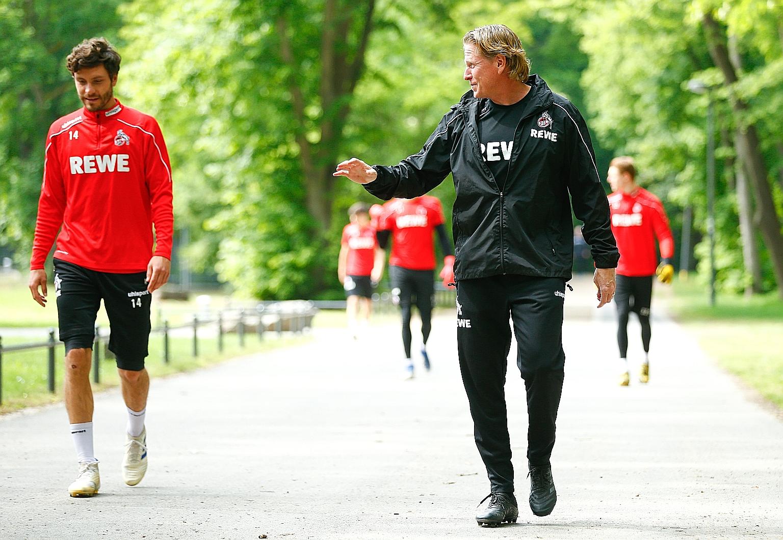 Cologne captain Jonas Hector and coach Markus Gisdol keeping their distance as they head to the training ground yesterday. PHOTO: REUTERS