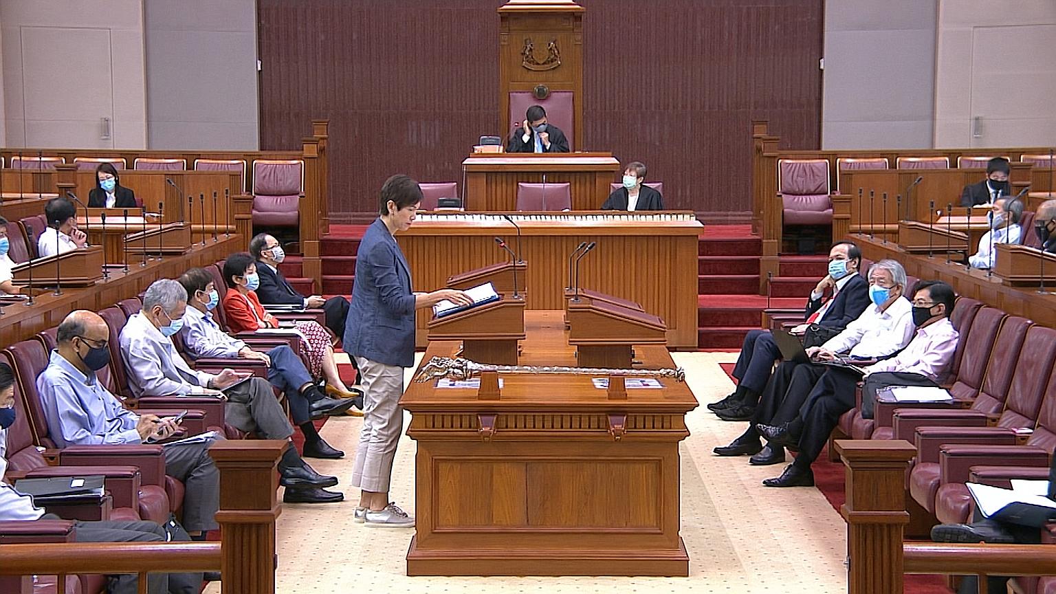 Manpower Minister Josephine Teo speaking yesterday in Parliament, where all MPs donned face masks for the first time. They removed them only when speaking so that they could be heard clearly. PHOTO: GOV.SG