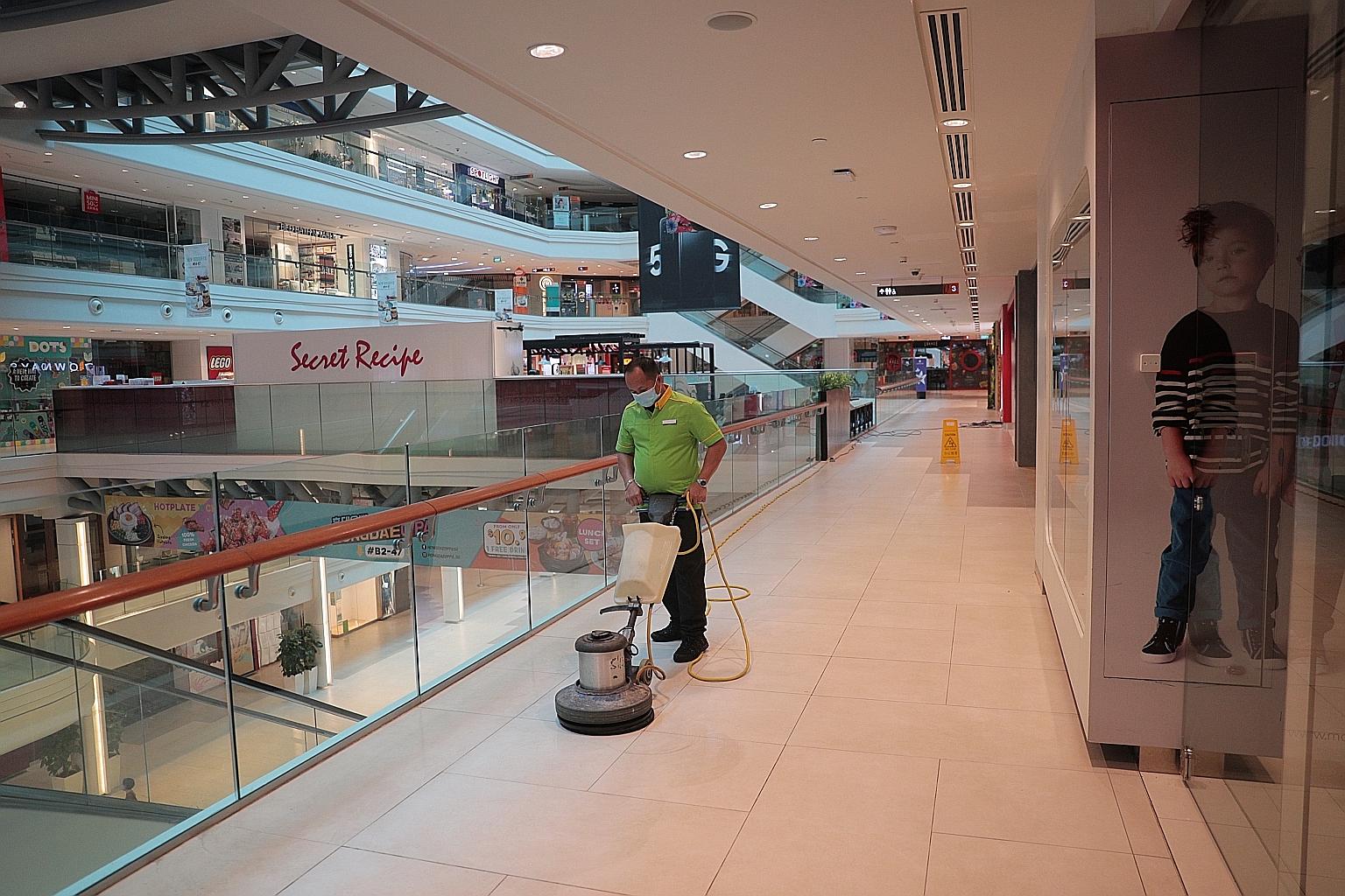 A cleaner at work in Plaza Singapura mall yesterday as shops and businesses remain shuttered for the extended circuit breaker period that ends on June 1. While it was a difficult decision to implement and extend the circuit breaker as businesses and
