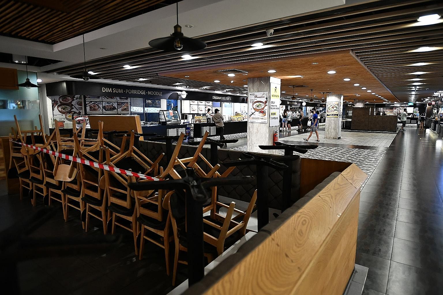 Tables and chairs stacked up in the foodcourt of Junction 8 mall on Tuesday, amid circuit breaker measures. Experts suggest dining-in at hawker centres, foodcourts or restaurants will not be allowed to resume so soon even when Singapore finally relax