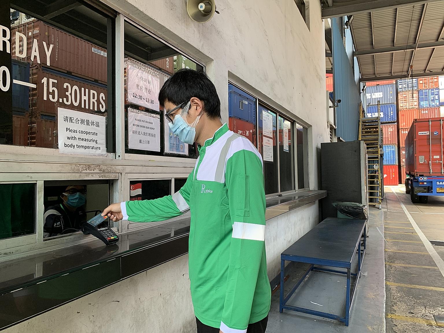 A driver using the DBS Logistics Purchasing Card to settle payment at one of Yang Kee Logistics' container depots in Tuas.