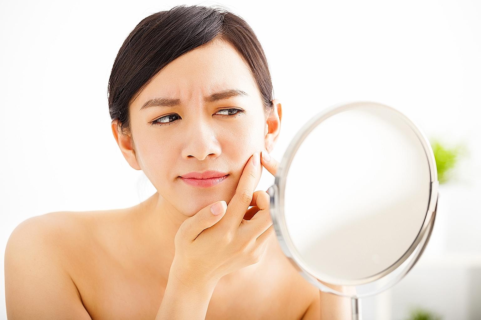 Kew Organics founder Lily Kew, demonstrating a DIY facial massage here, says to hydrate the skin often.