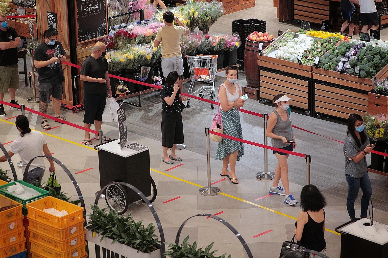 People queueing to enter Cold Storage supermarket at Great World City yesterday. A foremost concern among readers was the circuit breaker, with over 800 queries received by ST. In fact, ST received the highest number of questions on April 8 - a day a