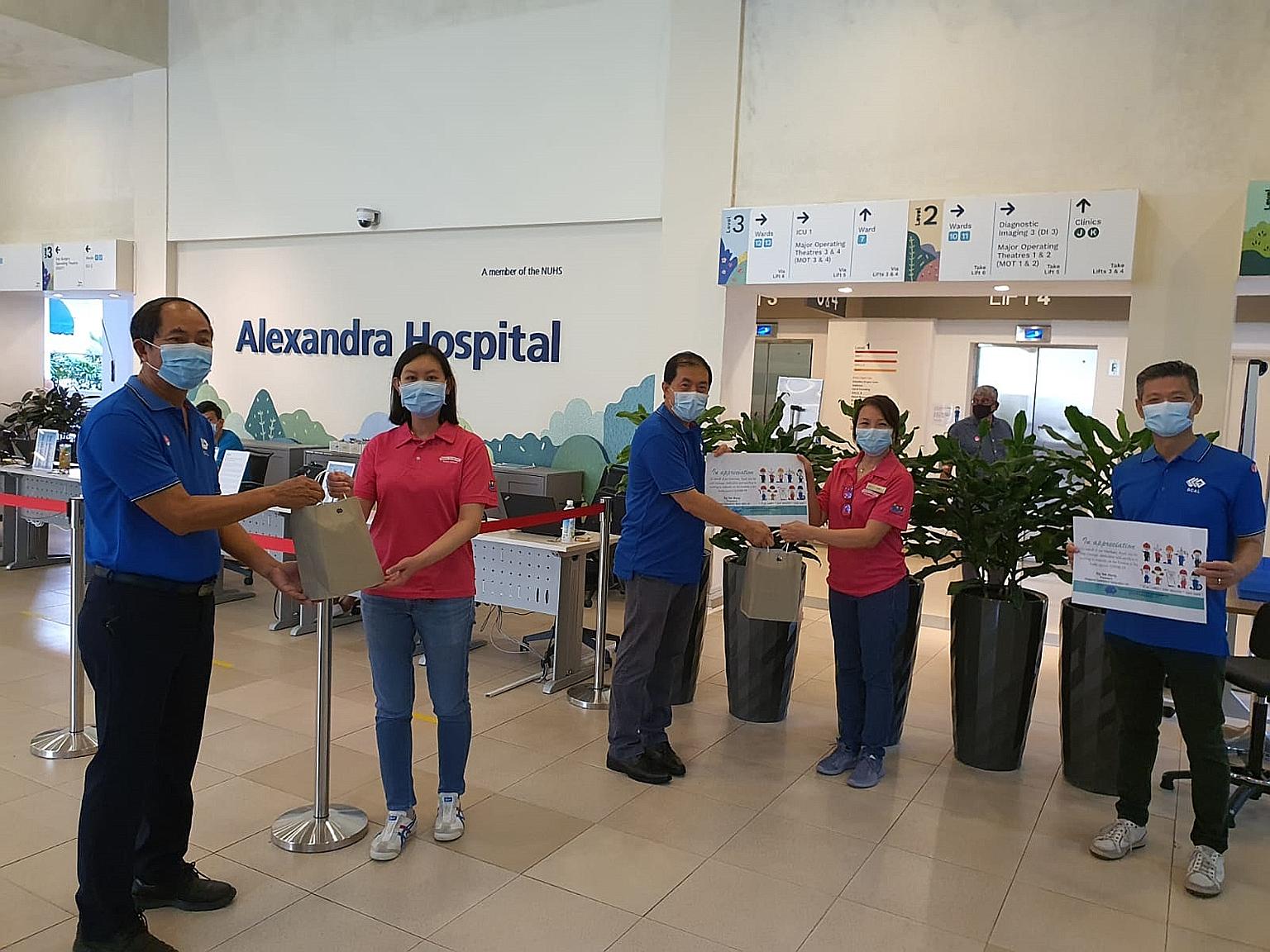 Singapore Contractors Association Limited's second vice-president Quek Hong Peng (far left) and president Ng Yek Meng presenting care packages to Alexandra Hospital's advanced practice nurse Wendy Yue and assistant director of nursing Janet Lam respe
